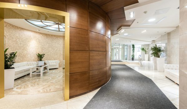 A modern residential lobby with concierge staff