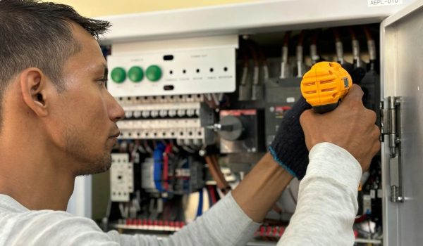A technician fixing a building component or inspecting an HVAC system